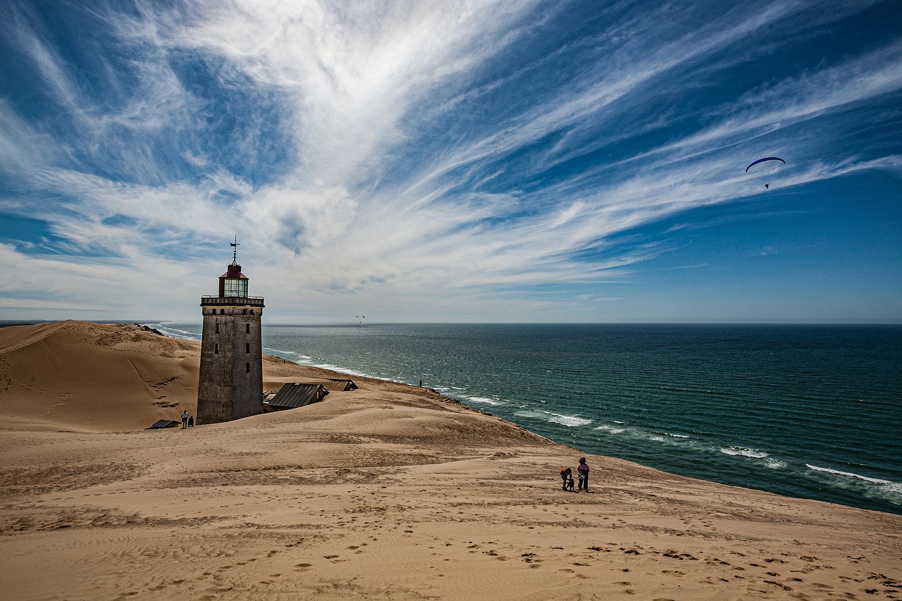 A lighthouse on a coastal cliff, the lantern still turning against an open sky.